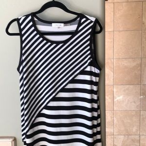 Black and white striped top. Size Medium. Sleeveless. One small hole on bottom.